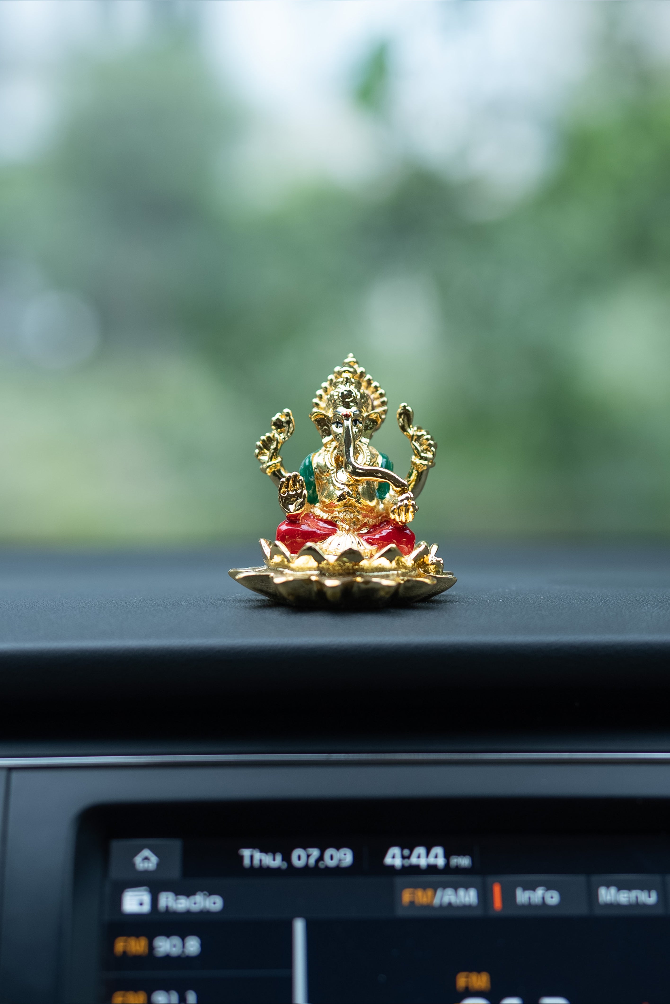 Gold Ganesha Murti on Lotus