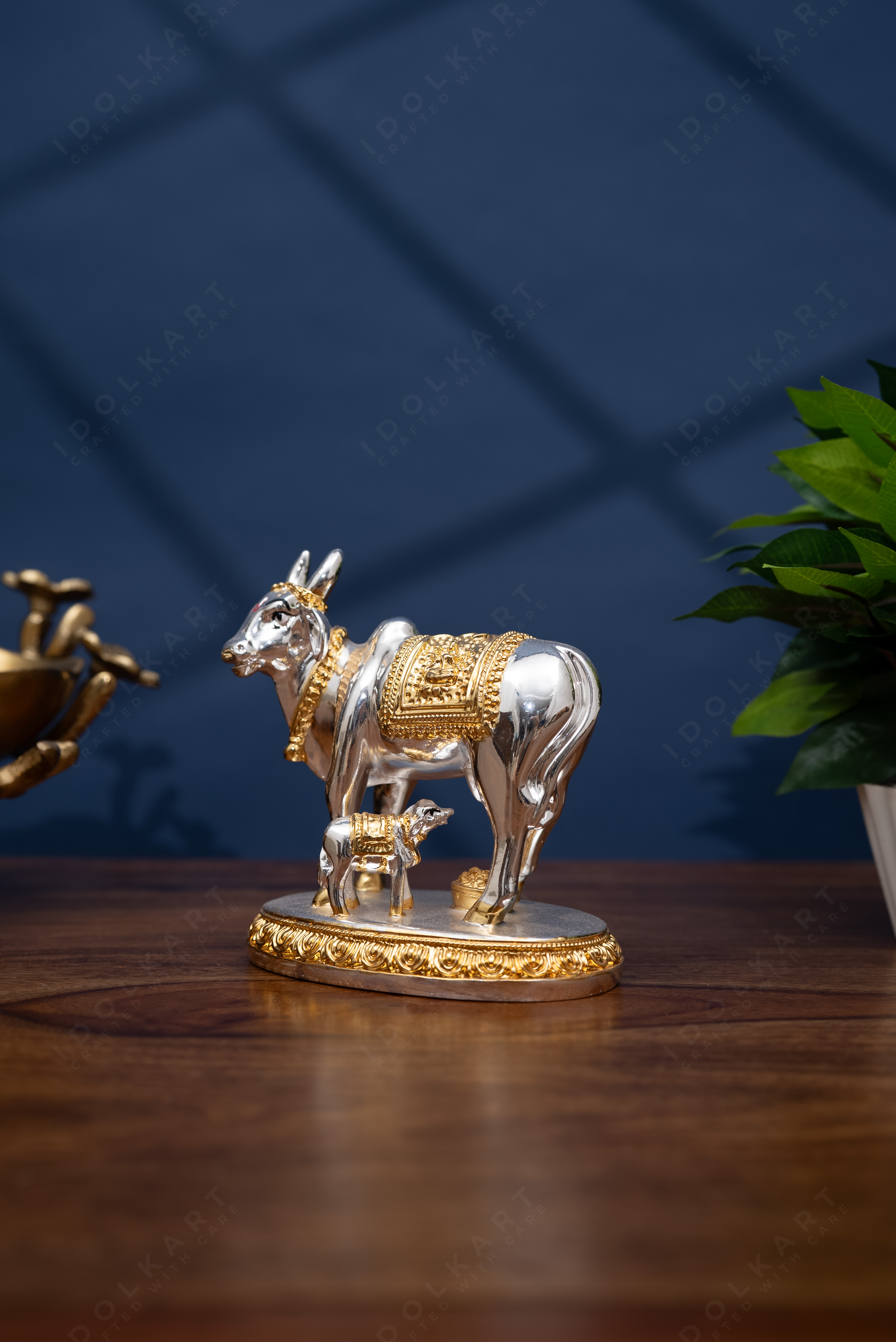 Gold and silver coated Kamdhenu idol in table